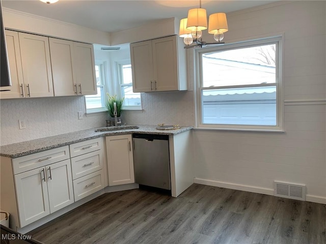 kitchen with dark hardwood / wood-style floors, white cabinets, hanging light fixtures, stainless steel dishwasher, and light stone countertops