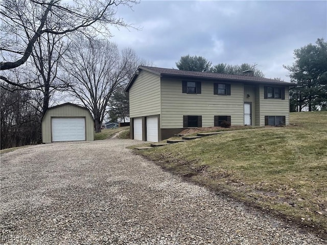 raised ranch featuring a garage and a front yard