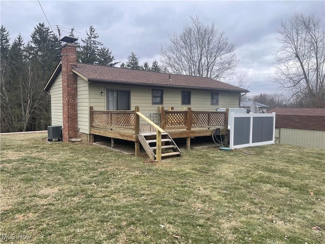 rear view of house featuring a yard, a deck, and central air condition unit