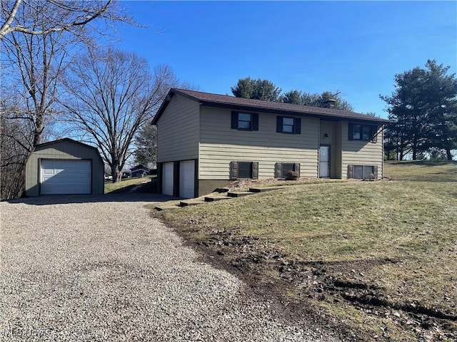 view of front of house with a garage, an outdoor structure, and a front yard