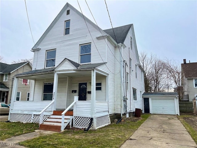 view of front facade with a garage, an outdoor structure, a porch, and a front yard