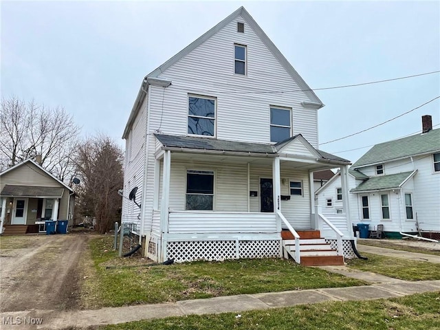 view of front of house with a front yard and covered porch