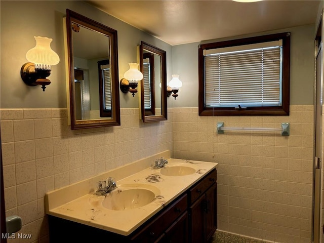 bathroom with vanity and tile walls