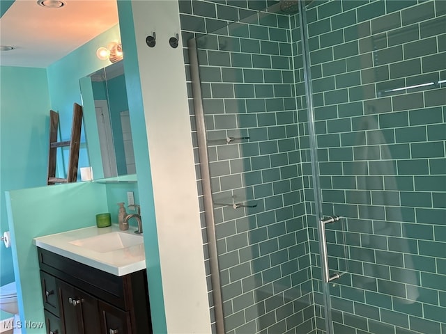 bathroom featuring vanity and a tile shower