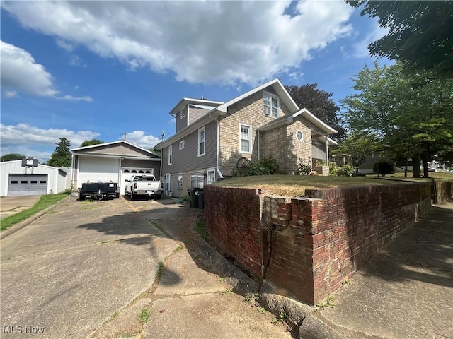 view of front of home featuring a garage and an outdoor structure