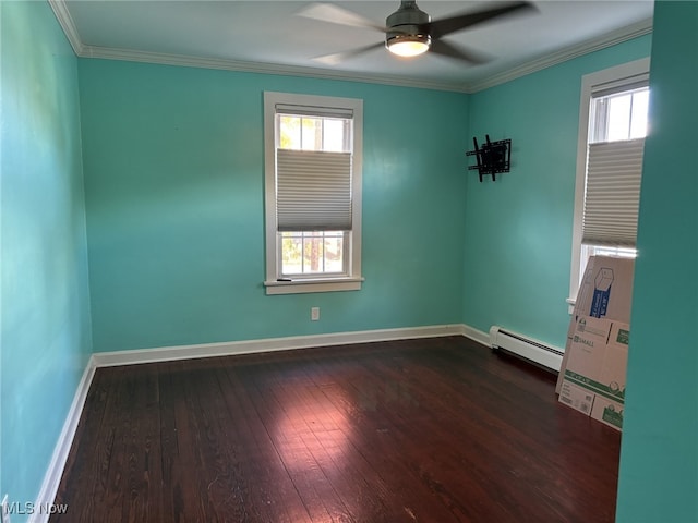 spare room featuring crown molding, a baseboard heating unit, ceiling fan, and dark hardwood / wood-style floors