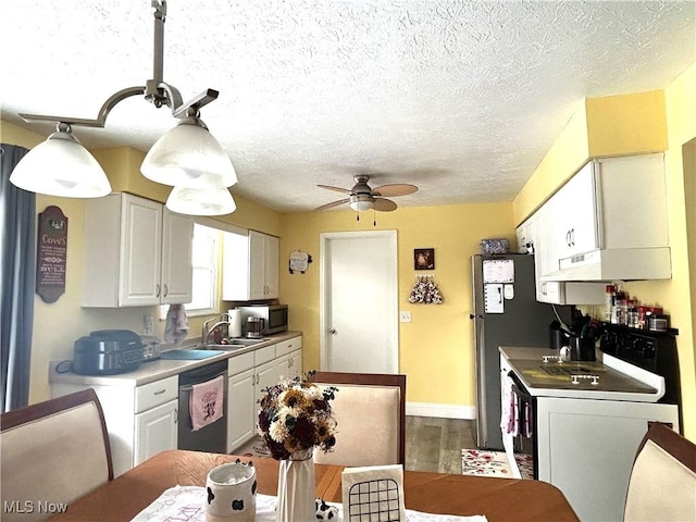 kitchen featuring appliances with stainless steel finishes, white cabinetry, hardwood / wood-style flooring, ceiling fan, and a textured ceiling