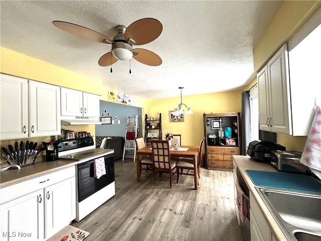 kitchen featuring pendant lighting, electric range, white cabinetry, and hardwood / wood-style flooring