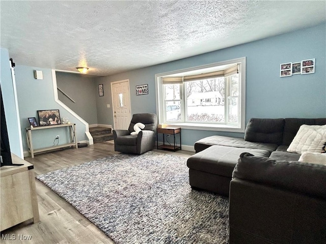 living room with hardwood / wood-style floors and a textured ceiling