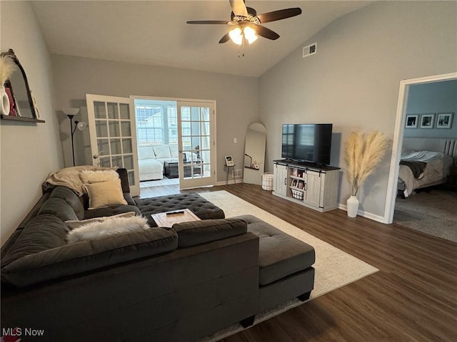 living room with lofted ceiling, dark hardwood / wood-style flooring, french doors, and ceiling fan