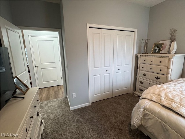 bedroom featuring dark carpet and a closet