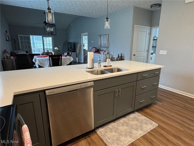 kitchen featuring sink, a textured ceiling, dark hardwood / wood-style floors, dishwasher, and pendant lighting