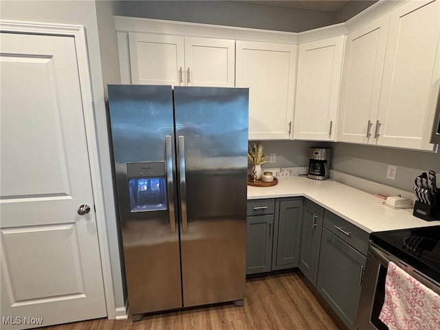 kitchen with gray cabinets, stainless steel appliances, dark hardwood / wood-style floors, and white cabinets