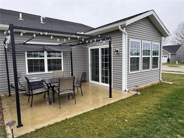 rear view of property with a yard, a pergola, and a patio