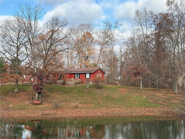 exterior space featuring a front yard and a water view