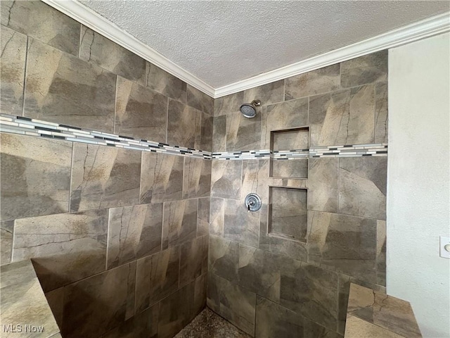 interior details featuring a tile shower, a textured ceiling, and ornamental molding