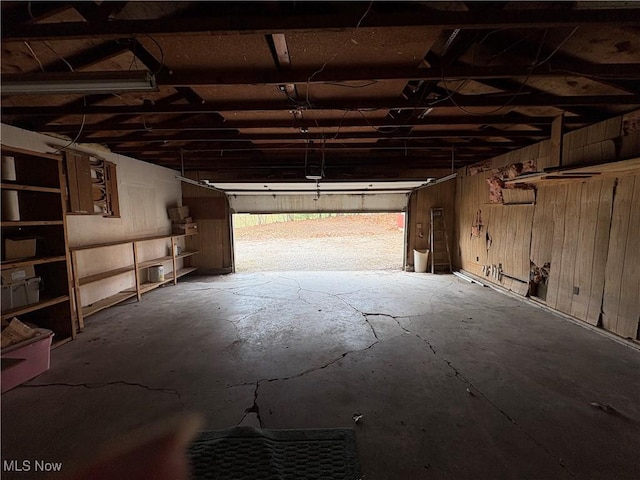 garage featuring wood walls