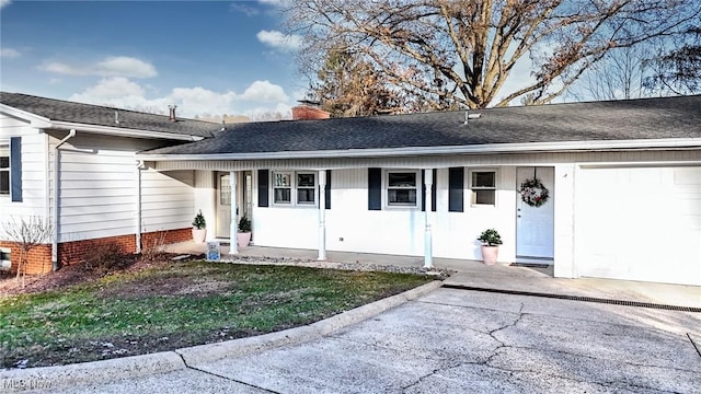 view of front of home featuring a garage and a porch