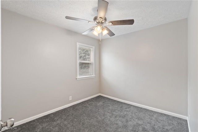 empty room featuring ceiling fan, dark carpet, and a textured ceiling