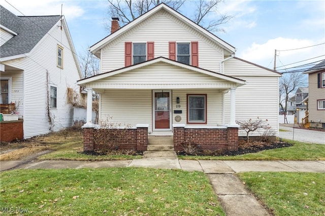 view of front of house with a front yard and covered porch