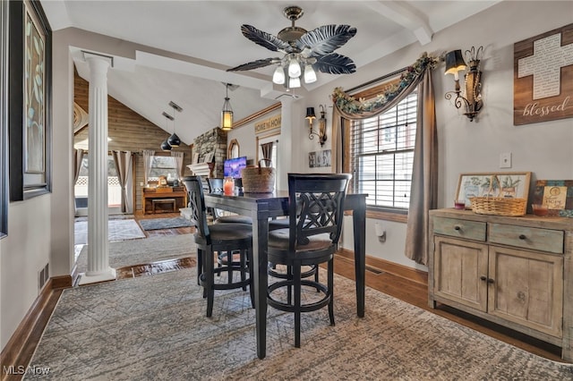 dining area featuring vaulted ceiling with beams, dark hardwood / wood-style floors, ceiling fan, and ornate columns