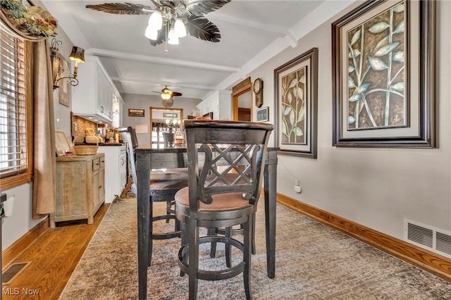 dining area with ceiling fan, a healthy amount of sunlight, and light wood-type flooring