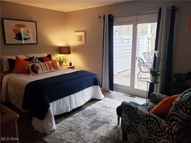 bedroom featuring light hardwood / wood-style flooring and access to exterior