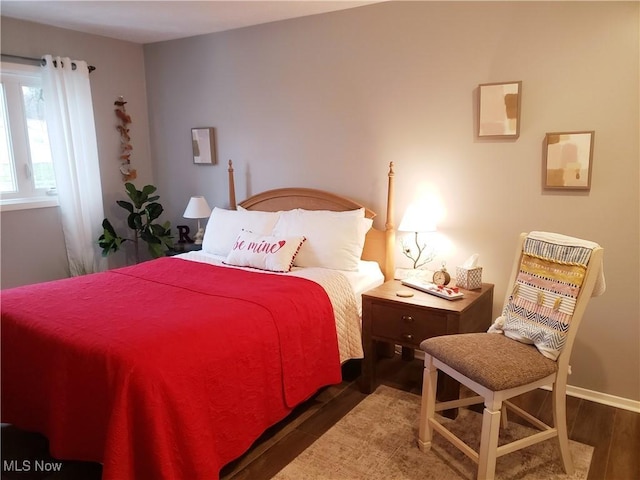 bedroom with dark hardwood / wood-style flooring