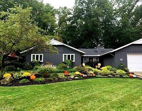 view of front of property with a front yard and a garage