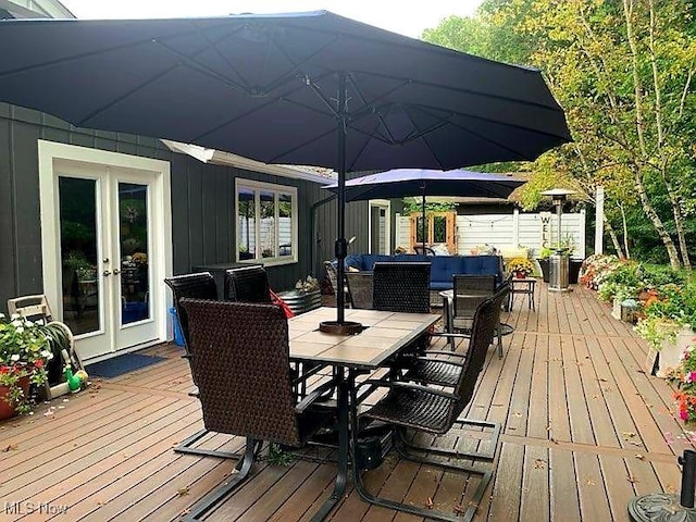 wooden terrace with french doors and an outdoor living space