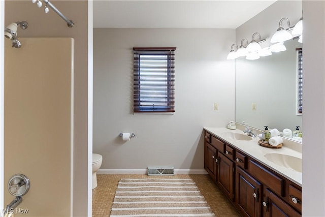 bathroom featuring tile patterned flooring, vanity, and toilet