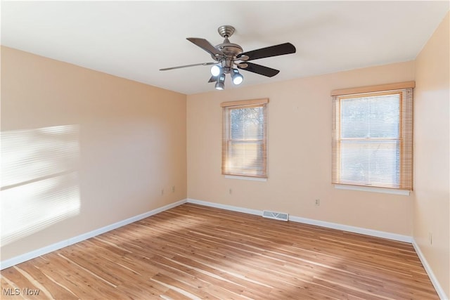 empty room featuring ceiling fan and light wood-type flooring