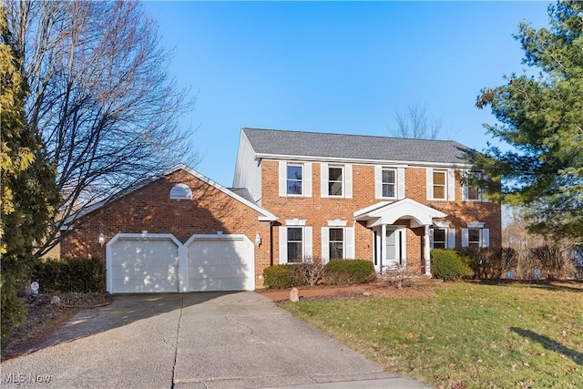 colonial-style house with a garage and a front yard