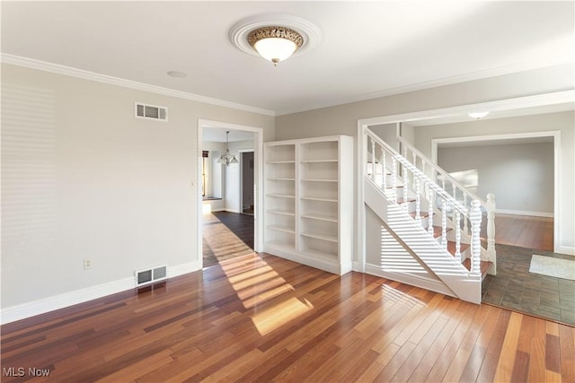 empty room with crown molding and dark hardwood / wood-style floors