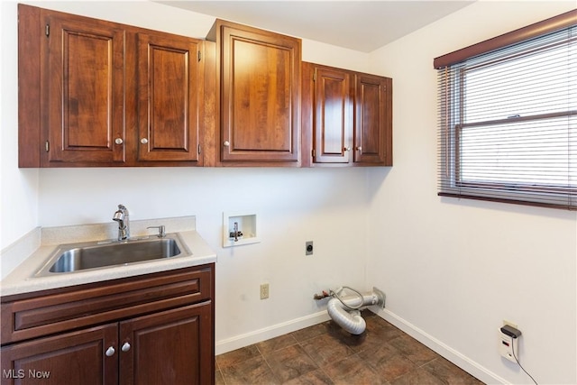 clothes washing area featuring cabinets, electric dryer hookup, sink, and hookup for a washing machine