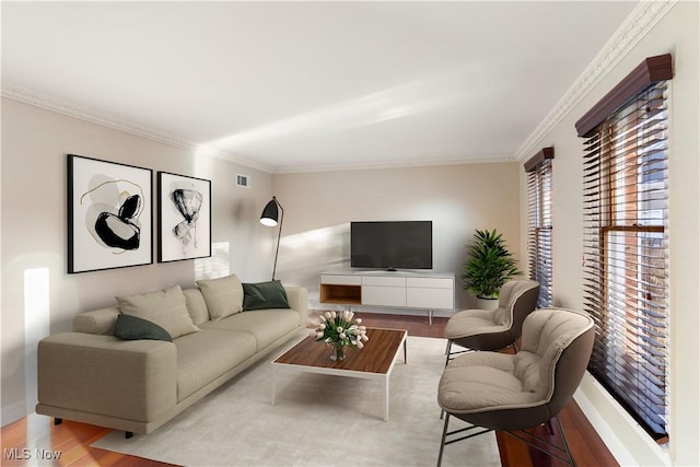 living room with ornamental molding and light hardwood / wood-style flooring