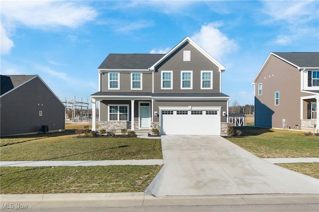 view of front of property with central AC unit, a garage, and a front yard