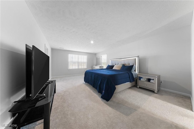 carpeted bedroom featuring a textured ceiling