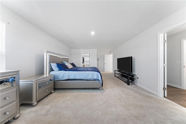 carpeted bedroom featuring a textured ceiling