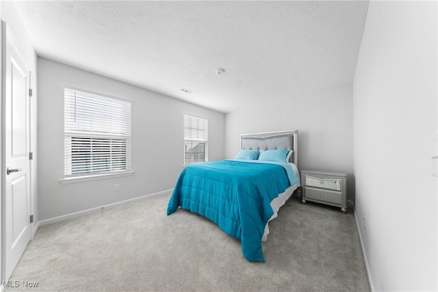 carpeted bedroom with a textured ceiling