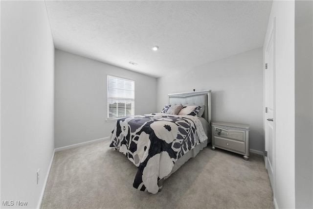 carpeted bedroom with a textured ceiling