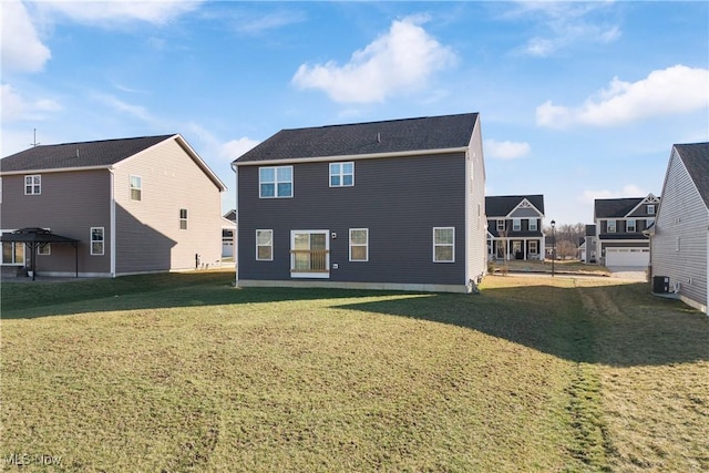 rear view of house featuring a yard and central AC unit