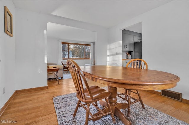 dining area with light hardwood / wood-style floors