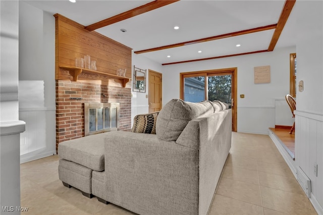 tiled living room with a fireplace and beam ceiling