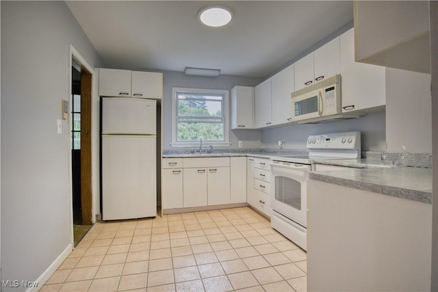 kitchen with light tile patterned floors, white appliances, sink, and white cabinets