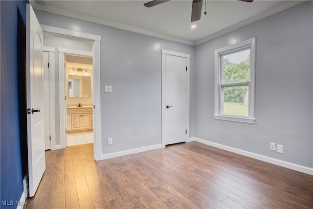 unfurnished bedroom with wood-type flooring, ornamental molding, and ceiling fan