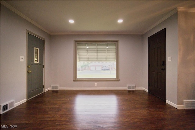 foyer entrance with crown molding and dark hardwood / wood-style floors