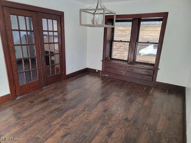 unfurnished dining area featuring dark hardwood / wood-style floors and french doors