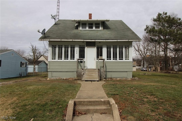 bungalow-style home with a front yard