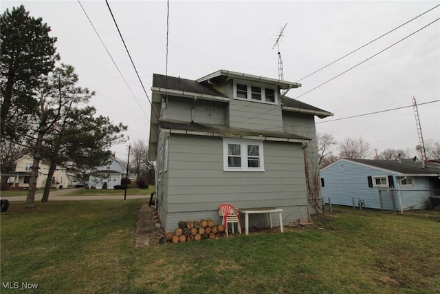 rear view of property featuring a yard